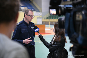 Umundurowany policjant, Komendant Miejski Policji w Elblągu inspektor Robert Muraszko, udziela wywiadu dla telewizji.